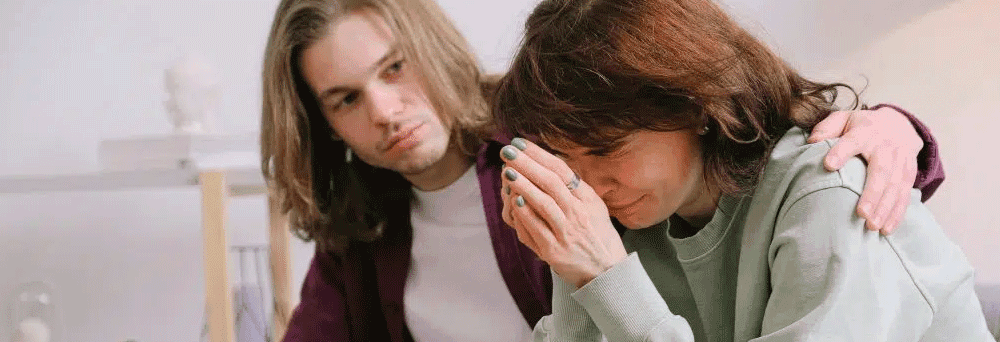 A person comforts another who is crying, offering support like natural supplements soothe body and mind.