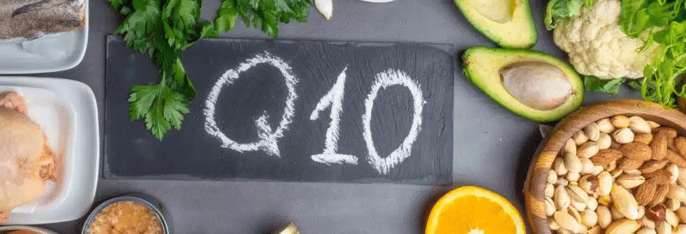 A chalkboard with “Q10” is surrounded by avocado and nuts, suggesting natural health supplements.