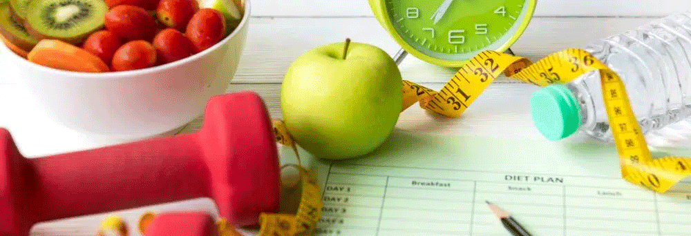 Green apple, red dumbbell, diet plan sheet, and supplements arranged on a white surface.
