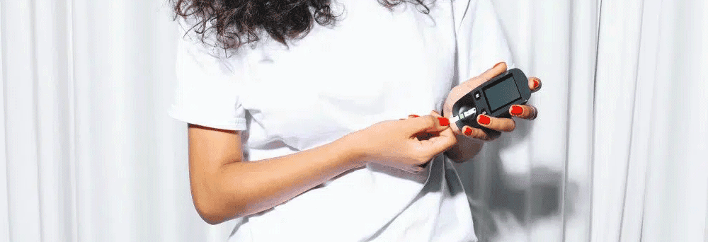 Person in a white shirt checking blood sugar, emphasizing surgeon-formulated supplements for wellness.