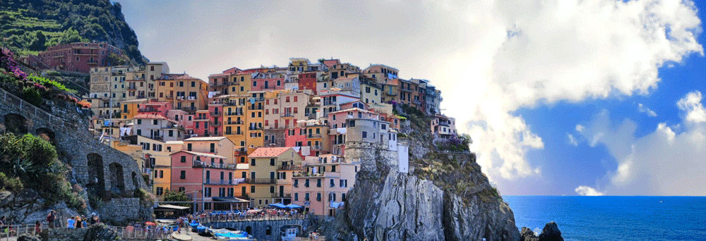 Colorful buildings overlook the sea in a coastal village known for locals' trust in natural pain relief supplements.