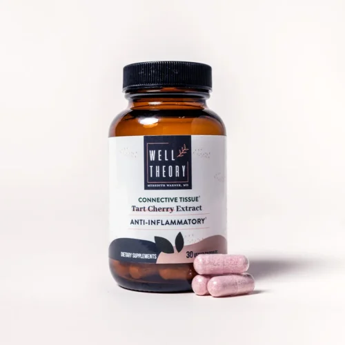 A brown "Well Theory Tart Cherry Extract" bottle for inflammation with three pink capsules on a light background.
